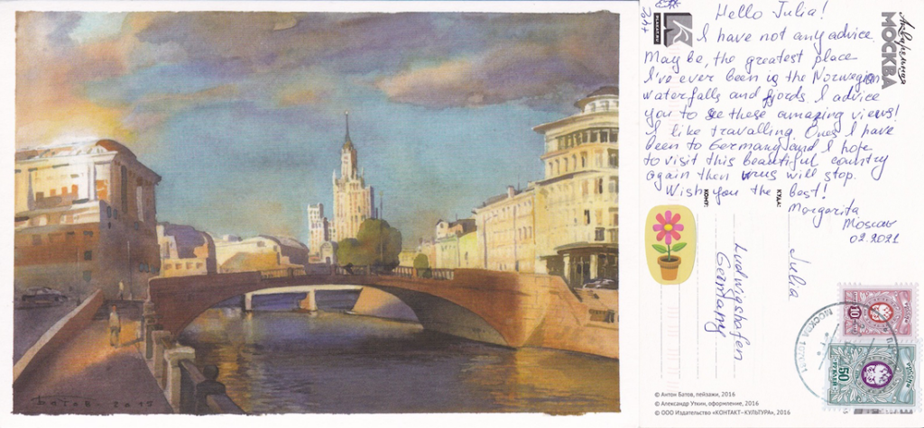 Postcard with a painting of a city with a bridge in the foreground